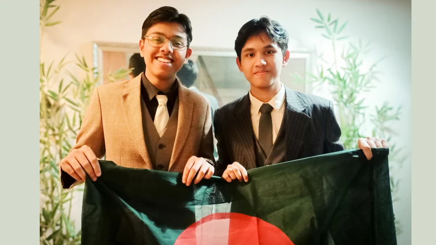 Shafi and Sabik Bin Sultan holding the Bangladesh flag.